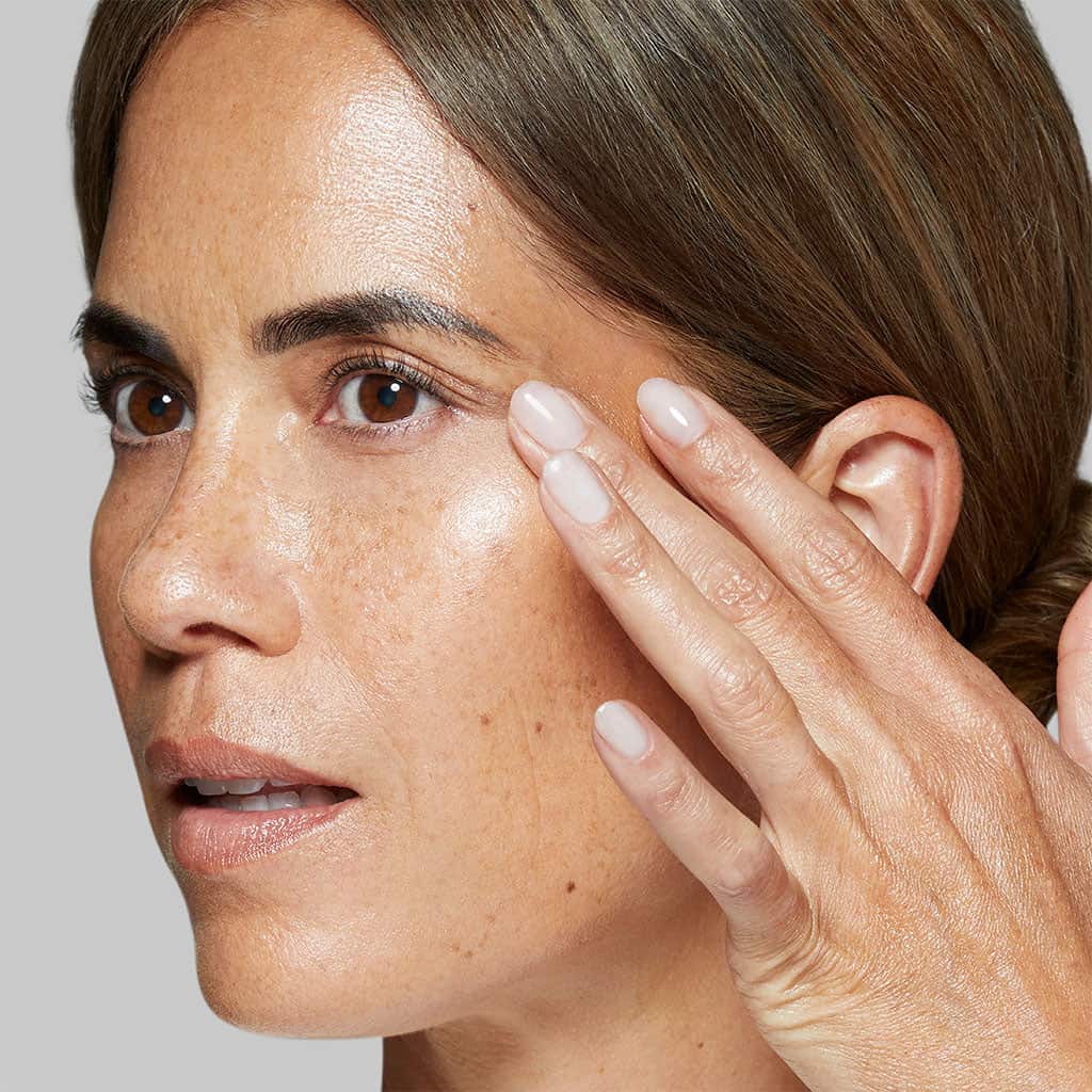 model applying circular hydration serum to face